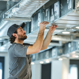 u1565576727_Central-European_HVAC_technician_installing_air-c_e66d6197-5cf6-4bbe-bb5c-afb99e29d666_2